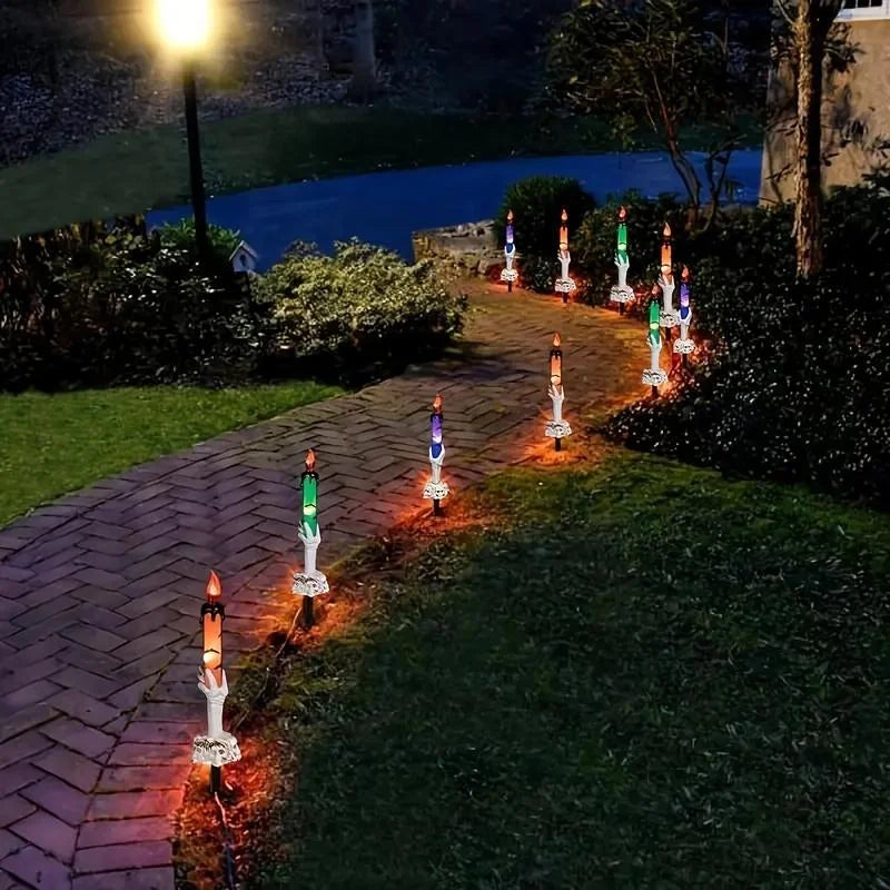 Skeleton Hands Hold Lighted Candle Stakes