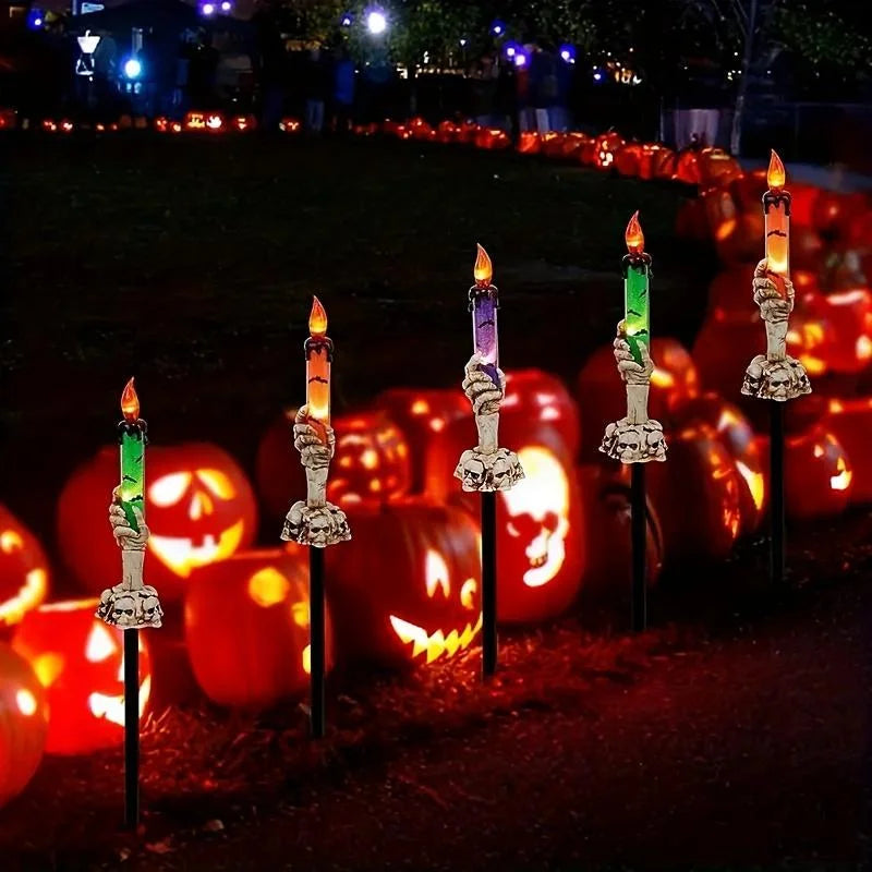 Skeleton Hands Hold Lighted Candle Stakes