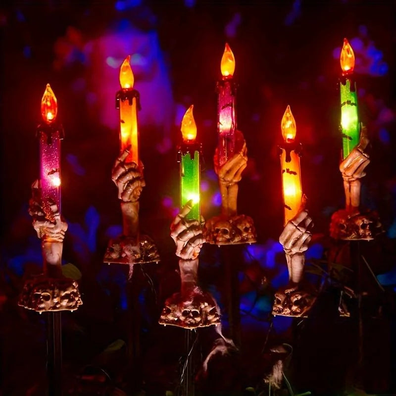 Skeleton Hands Hold Lighted Candle Stakes